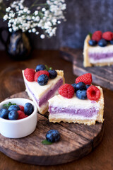 Cheesecake with berries on a wooden background. Side view.