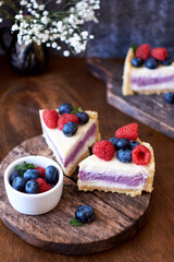 Cheesecake with berries on a wooden background. Side view.