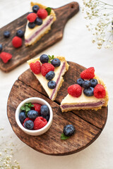 Cheesecake with berries on a white background. Side view.