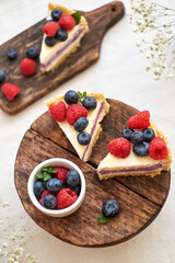 Cheesecake with berries on a white background. Side view.