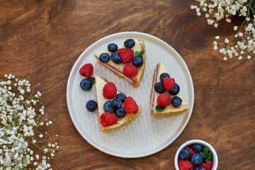 Cheesecake with berries on a wooden background. Top view.