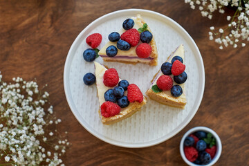 Cheesecake with berries on a wooden background. Top view.