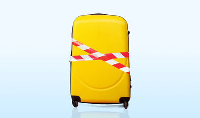 Colorful baggage wrapped in red and white barrier tape