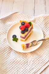 Cheesecake with berries on a white background. Side view.
