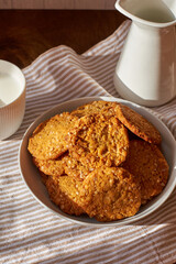 Honey oatmeal chip cookies. Side view. Milk.