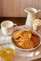 Honey oatmeal chip cookies. Side view. Milk.