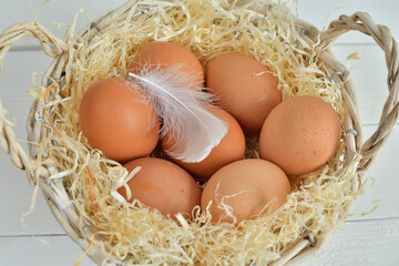 basket with organic eggs on white background.Happy Easter