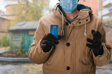 Young man offering payment for home bills by dedit card