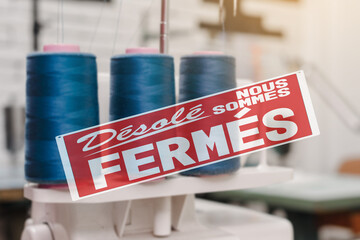 sorry we are closed lettering in french. Bankrupcy of small fashion atelier caused by covid-19 virus outbreak