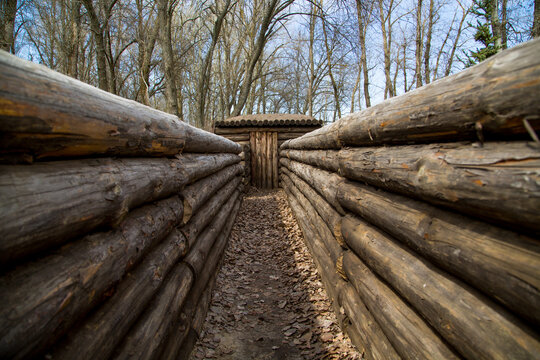 A trench fortified with logs with a dugout. Victory Day. The Second World War. Monument to the fallen soldiers.