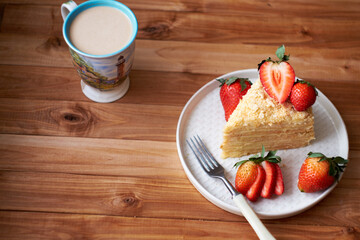 Napoleon cake with strawberries on a wooden background. Top view.