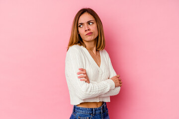 Young caucasian woman isolated on pink background dreaming of achieving goals and purposes