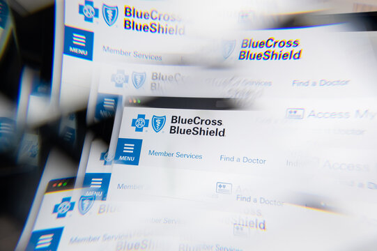 Milan, Italy - APRIL 10, 2021: Blue Cross Blue Shield Association logo on laptop screen seen through an optical prism. Illustrative editorial image from Blue Cross Blue Shield Association website.