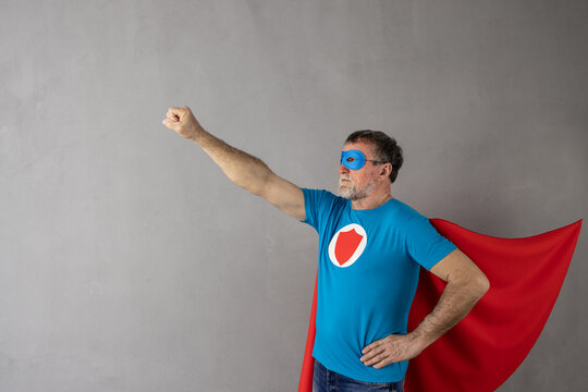 Senior man wearing superhero costume