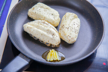Halloumi cheese frying in grill pan.