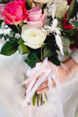 Bride holds beautiful vibrant wedding bouquet