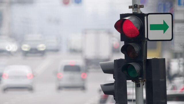 Traffic light at a large intersection in urban scenery. Traffic on the streets of the city which regulates traffic lights. Regulation of traffic in the city traffic lights with the entire cycle of its