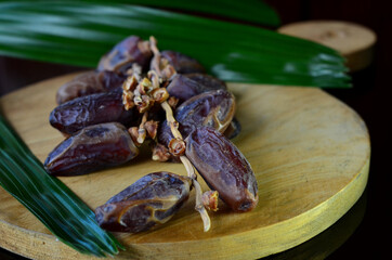 kurma or dry dates fruits symbolizing Ramadan on dark background.
