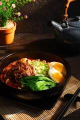 a bowl of spicy noodle with various topping or known as  ramen 