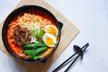 a bowl of spicy noodle with various topping or known as  ramen 