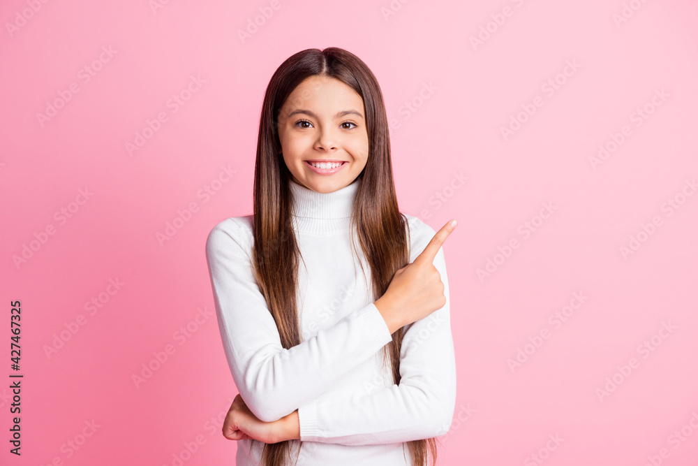 Sticker Photo of optimistic nice brunette girl point empty space wear white sweater isolated on pastel pink color background