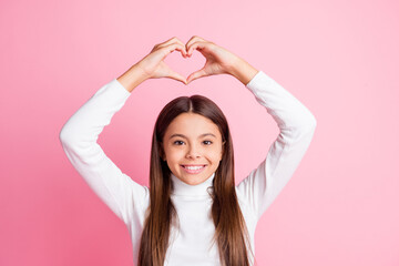 Obraz na płótnie Canvas Photo of optimistic nice brunette girl show heart wear white sweater isolated on pastel pink color background