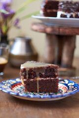 Chocolate cake with white cream and caramel sauce.