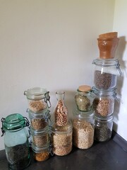 Vintage glass jars with grains and herbs