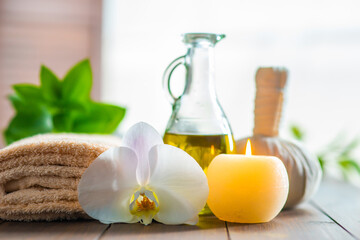 Spa background. Towel, candles, orchid flowers and herbal balls. Massage, oriental therapy, wellbeing and meditation.