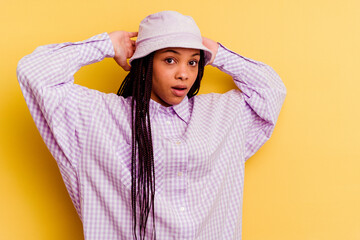 Young african american woman isolated on yellow background screaming, very excited, passionate, satisfied with something.