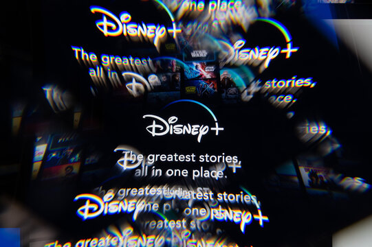 Milan, Italy - APRIL 10, 2021: Disney plus logo on laptop screen seen through an optical prism. Illustrative editorial image from Disney plus website.