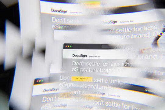 Milan, Italy - APRIL 10, 2021: Docu Sign logo on laptop screen seen through an optical prism. Illustrative editorial image from Docu Sign website.