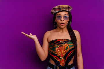 Young african american woman isolated on yellow background Young african american woman isolated on yellow background impressed holding copy space on palm.