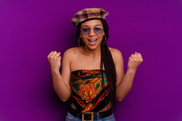 Young african american woman isolated on yellow background Young african american woman isolated on yellow background cheering carefree and excited. Victory concept.