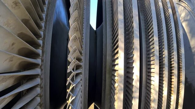 Steam turbine against nuclear power plant and sky 