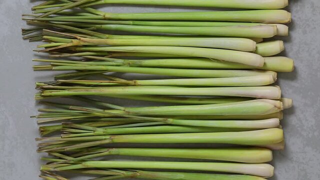 Fresh raw organic whole lemongrass stems close up in a row 