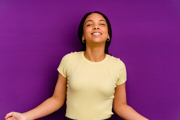 Young african american woman isolated on yellow background Young african american woman isolated on yellow background relaxed and happy laughing, neck stretched showing teeth.