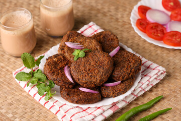 Many beef or chicken cutlet, tomato sauce Kerala South India. hot and spicy tea time snack on white plate traditional background. fried meat of veal, mutton or fish. Top view Indian snack non veg food