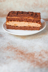 piece of chocolate cake with mousse cream sweet dessert vanilla cocoa cinnamon snack trend meal copy space food background rustic. top view