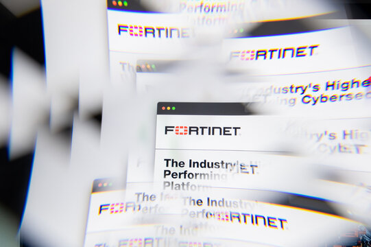 Milan, Italy - APRIL 10, 2021: Fortinet logo on laptop screen seen through an optical prism. Illustrative editorial image from Fortinet website.