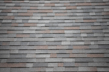 roof shingle background and texture. dark asphalt tiles on the roof