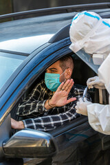 Man refuses medical worker in PPE trying to performing drive-thru COVID-19 test