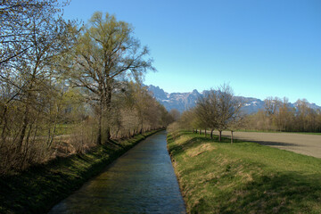 Small canal in the nature in Vaduz in Liechtenstein 4.4.2021