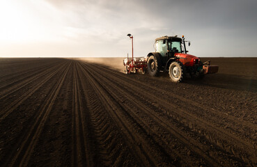 Farmer with tractor seeding