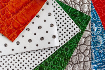 Variety of leather samples of different textures and colors, color choice for manufacturing of fashion accessories