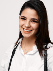 happy woman in white shirt with suspenders laughs and makeup on face