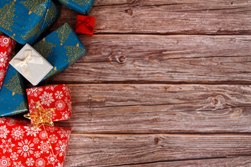 Christmas gift box on wooden table with christmas ornaments, closeup.