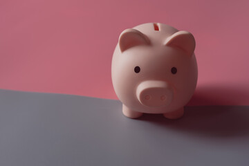 Cute Pink piggy Bank on pink and gray background, Concept of Saving  money for the future, investment budget wealth business retirement, financial, business, banking with copy space,Pastel colors.