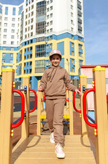 Fototapeta na wymiar Cute girl walks in the playground in sunny weather