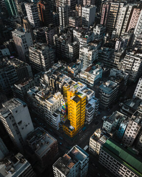Hong Kong - 14 February 2019: Aerial view of urban grid on Kowloon and yellow tower at sunset, Hong Kong